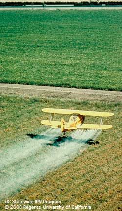 Aerial spraying of a crop field.