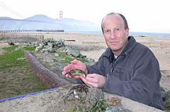 Ted Grosholz holding a European green crab