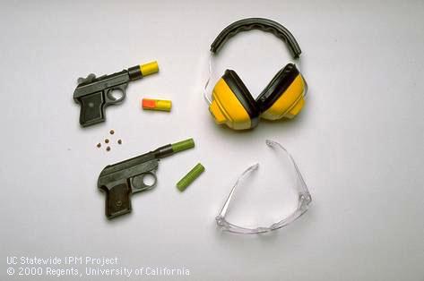 Noise-making devices used to frighten birds: bird bombs and bird whistlers with ear protectors and safety glasses.