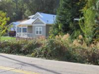 Blackberries growing along a roadway and encroaching into the home landscape.