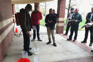 Properly calibrating a backpack sprayer ensures the correct amount of pesticide is applied and helps prevent extra pesticide from moving offsite into waterways. Credit: Karey Windbiel-Rojas, UC IPM. Copyright 2019 Regents of the University of California. Photo by: Karey Windbiel-Rojas, UC IPM