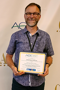 Petr Kosina accepts a well-deserved Gold Award for his work on the online course Diagnosing Herbicide Injury. As part of his submission, Kosina made a video about the behind-the-scenes thought and work that makes science information engaging. Photo by: Tunyalee Martin, UC IPM.