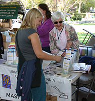 Else-Marie Augusti asks Mary Strohl, a master gardener for Yolo County, a gardening question at the Davis Farmer’s Market.