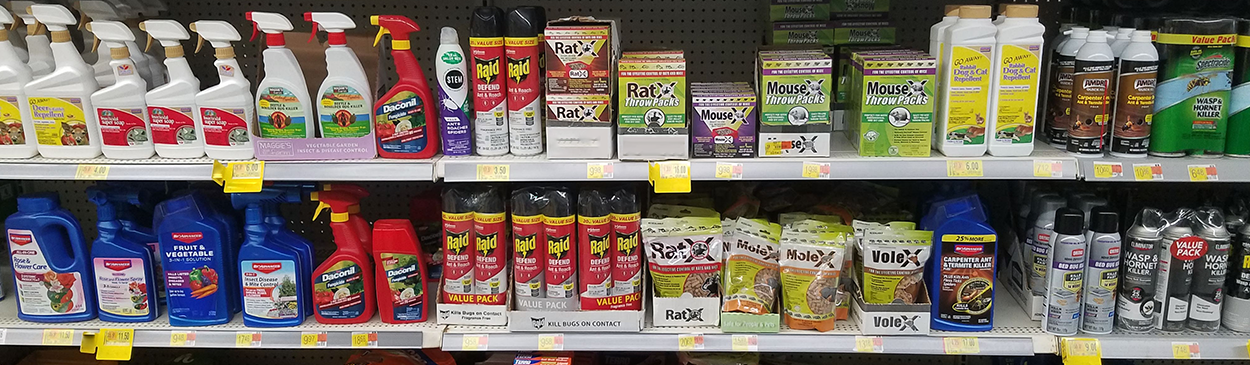 Shelves of various consumer pesticides in a retail store.